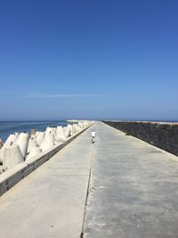 The baby is running around the pier. the westernmost point of russia.