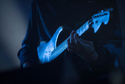 Close-up of man playing guitar