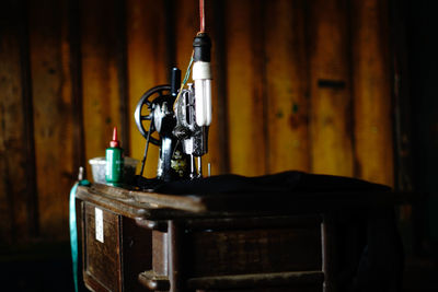 Sewing machine on table against wall