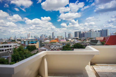 Buildings in city against cloudy sky