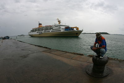 Man standing on sea against sky