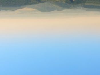 Scenic view of mountains against clear blue sky