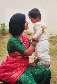 Side view of young woman looking at at farm