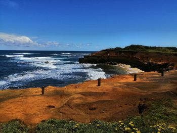 Scenic view of beach against blue sky