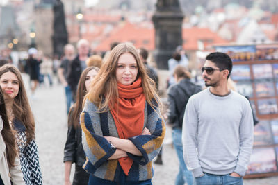 Portrait of smiling young woman standing in city