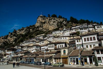 Low angle view of buildings against clear blue sky