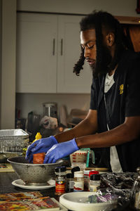 Adult man in the kitchen cooking 