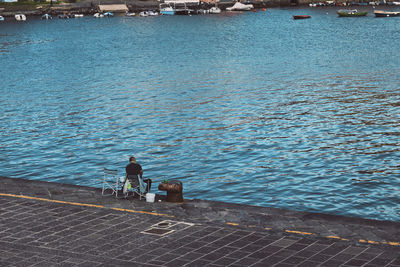 Rear view of people looking at sea