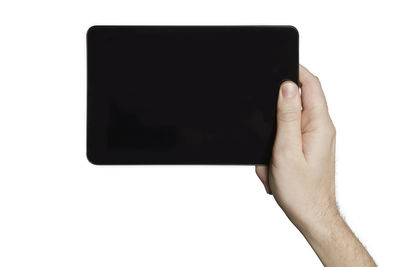 Close-up of hand holding smart phone against white background