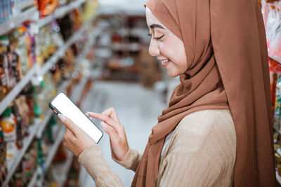 Midsection of woman using mobile phone