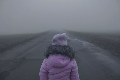 Rear view of woman on snow covered land