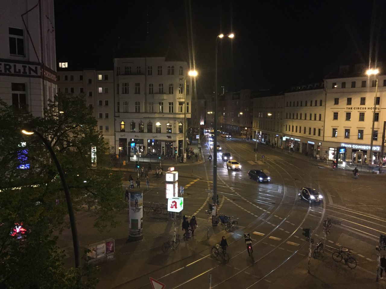 HIGH ANGLE VIEW OF ILLUMINATED CITY STREET AT NIGHT