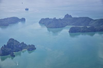 Scenic view of rocks in sea against sky