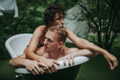 Couple in bathtub outdoors