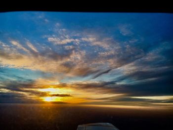 Close-up of airplane against sky during sunset