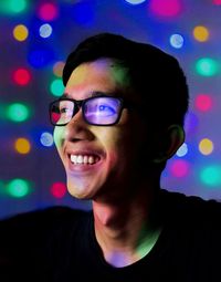 Portrait of smiling young man. man smiling with colorful light effect