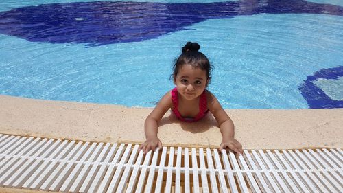 Portrait of girl in swimming pool on sunny day