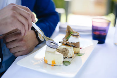 Close-up of man holding ice cream in plate