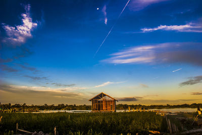 Scenic view of field against sky at sunset