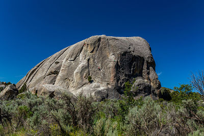 Low angle view of rock formation against sky