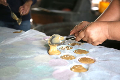 Midsection of person preparing food on table