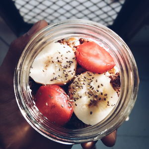 Cropped hand holding breakfast in container