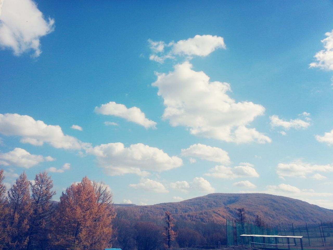 mountain, sky, tranquil scene, mountain range, tranquility, scenics, tree, cloud - sky, beauty in nature, landscape, cloud, blue, nature, non-urban scene, cloudy, day, idyllic, outdoors, no people, low angle view