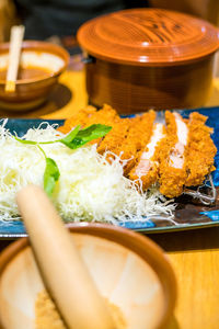 Cropped hand of person preparing food on table