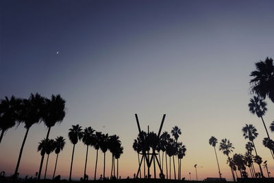 Low angle view of silhouette palm trees against sky during sunset