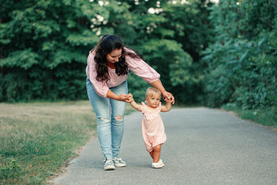 Full length of mother and daughter on tree