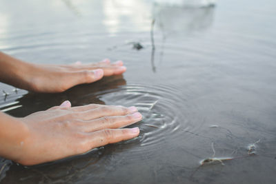 Hands of a woman above water