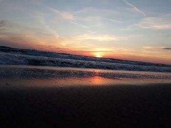 Scenic view of beach against sky during sunset