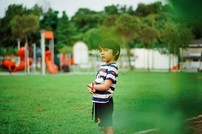 Full length of boy standing on grass