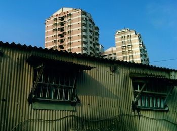 Low angle view of building against blue sky