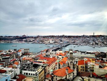 High angle view of townscape by sea against sky