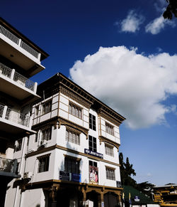 Low angle view of building against cloudy sky