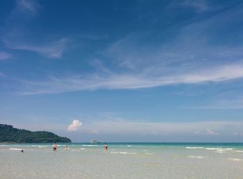 Scenic view of beach against blue sky