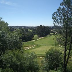 High angle view of golf course against clear sky
