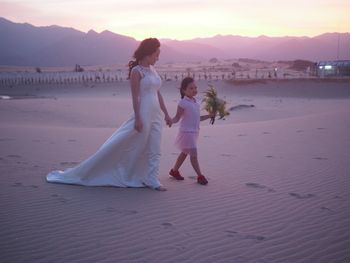 Full length of happy woman walking on beach