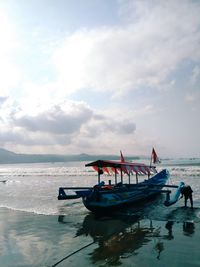 Boat moored on sea against sky