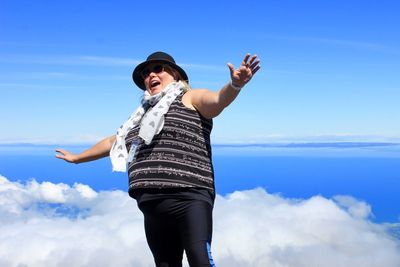 Low angle view of man standing against sky