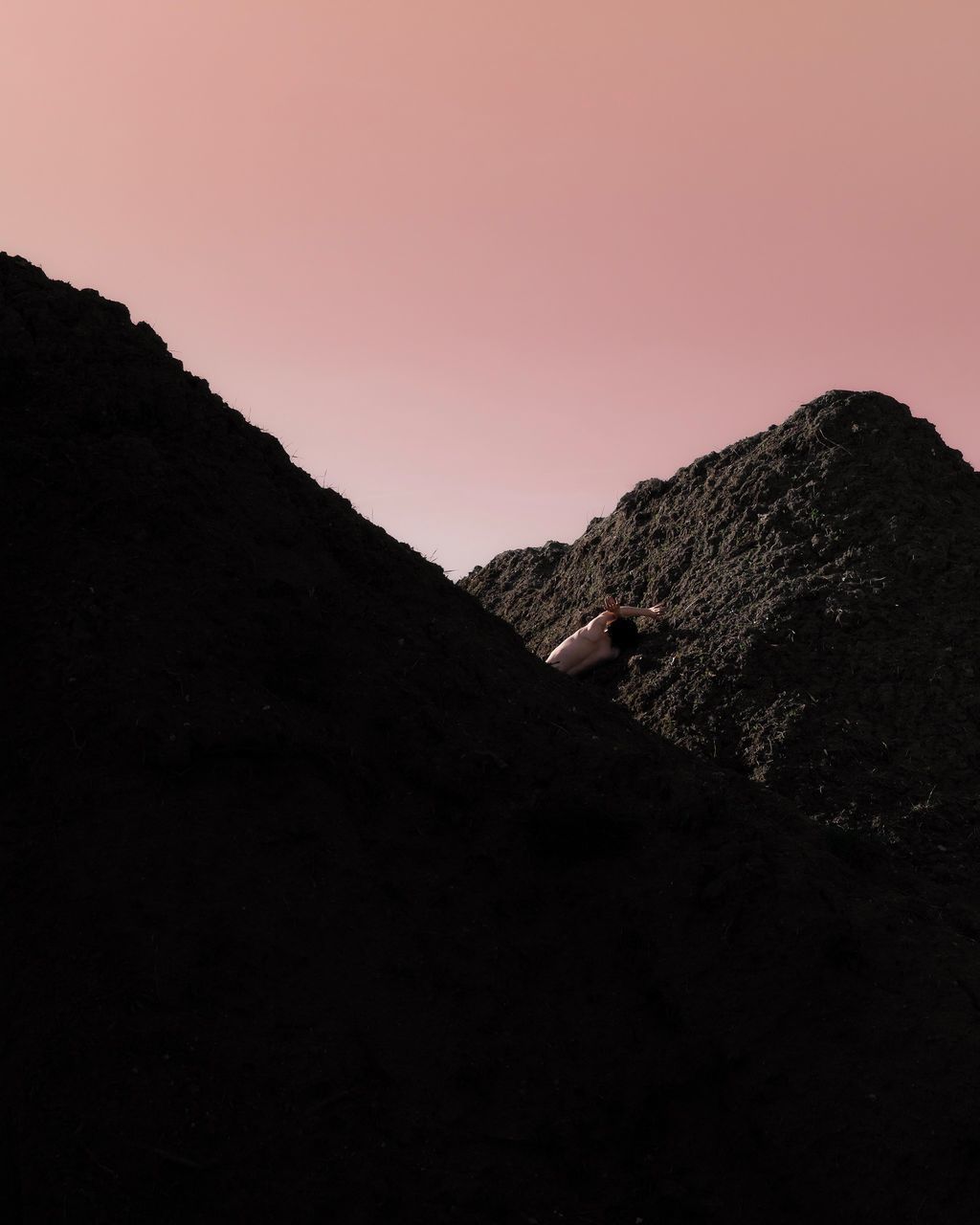 sky, mountain, copy space, beauty in nature, nature, real people, one person, tranquility, rock, tranquil scene, leisure activity, lifestyles, solid, rock - object, clear sky, scenics - nature, non-urban scene, standing, activity, outdoors