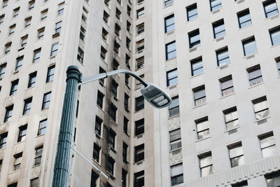 Low angle view of street light against modern building