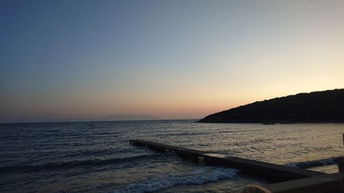 Scenic view of sea against clear sky during sunset