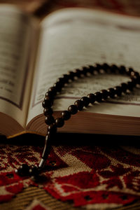 Close-up of bead necklace on book