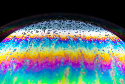Close-up of bubbles over black background