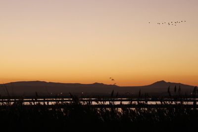 Scenic view of silhouette mountains against sky during sunset