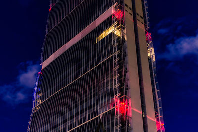 Low angle view of illuminated building against sky at night