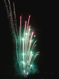 Low angle view of firework display at night