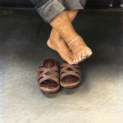 Low section of woman standing on tiled floor